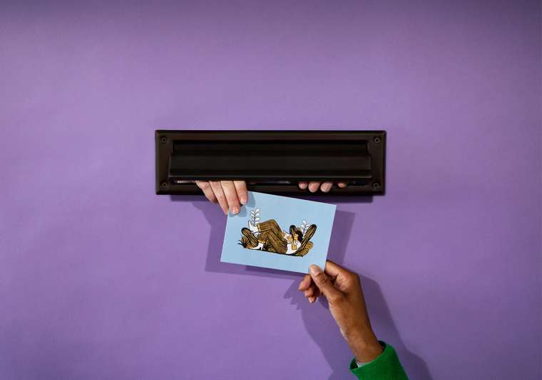 Person receiving postcard through letterbox via Mailchimp