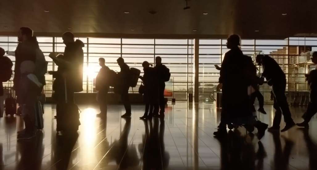 People queueing ready to go traveling