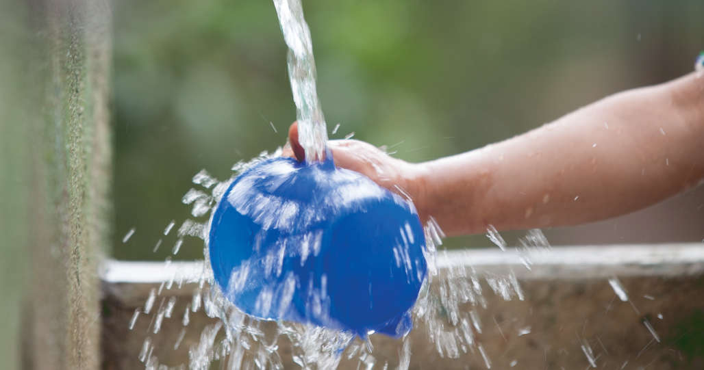 Kid washing his cup