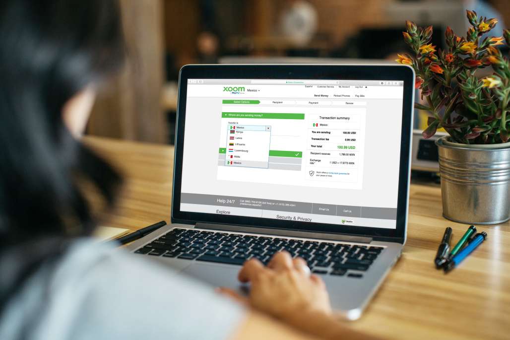 Person sending money using Xoom website on their laptop