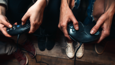 People playing video games using controllers
